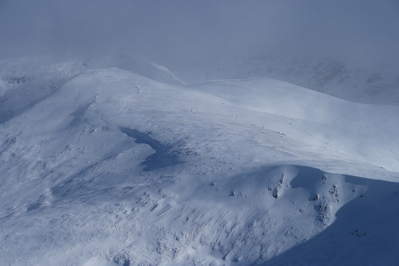 Dramatic snow-covered alpine landscape with mountain ridges