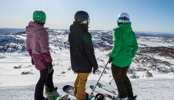 Snow-covered alpine village with ski chalets and mountain backdrop